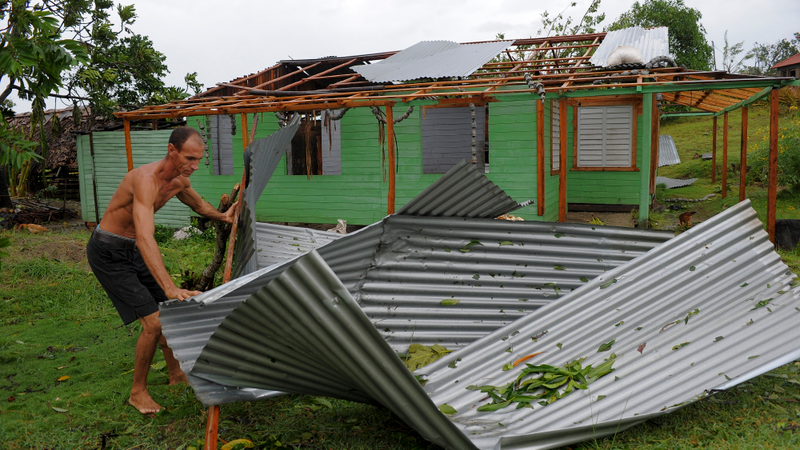A man works with damaged property in the Carbonera community of Guantanamo, Cuba following Hurricane Matthew, October 5, 2016. The storm slammed into Haiti and Cuba as a Category Four hurricane on October 4, 2016 but has since been downgraded to three, on a scale of five, by the US National Hurricane Center (NHC). Its winds were howling at 115 miles per hour. (Image: Getty)